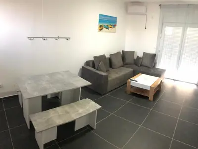 a living room with a couch and a table at Lanika Apartments in Ulcinj