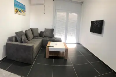 a living room with a couch and a coffee table at Lanika Apartments in Ulcinj