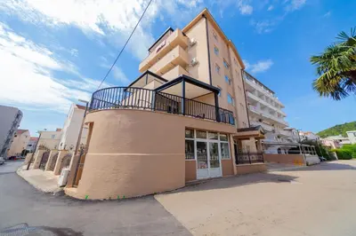a building with a balcony on the side of it at Azzuro apartments Budva in Budva