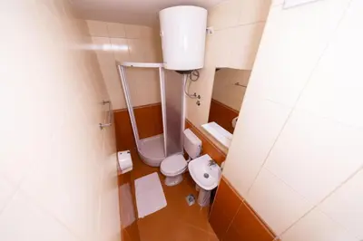 a small bathroom with a toilet and a sink at Azzuro apartments Budva in Budva