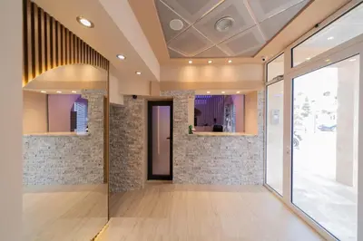 a lobby with a large glass door and brick walls at Azzuro apartments Budva in Budva