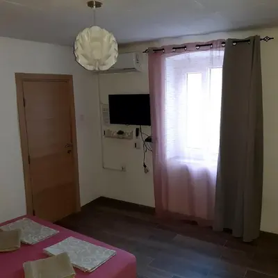 a room with a window and a pink curtain at vicky 1 in Kotor