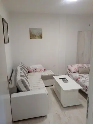 a living room with a couch and a coffee table at Apartmani M&V in Sutomore