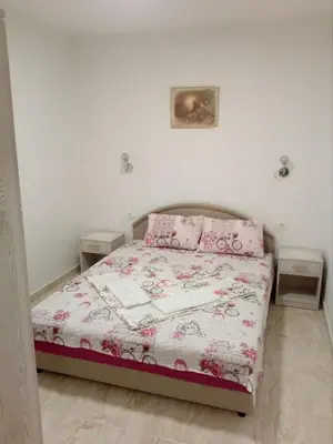 a bedroom with a bed and two night stands at Apartmani M&V in Sutomore