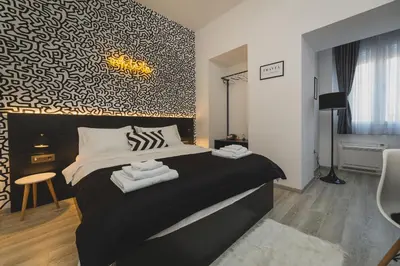 a bedroom with a bed with towels on it at Hotel Marienplatz Podgorica in Podgorica
