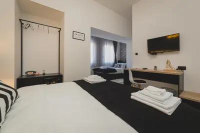 a bedroom with a large bed with towels on it at Hotel Marienplatz Podgorica in Podgorica