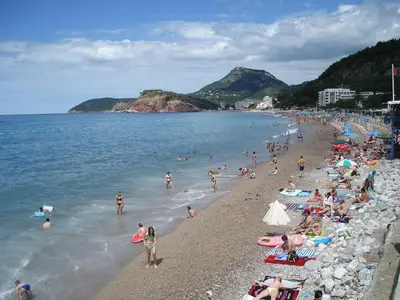 a group of people on a beach in the water at Dalukos Apartmani in Sutomore