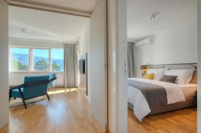 a bedroom with a bed and a desk and a chair at Fontana Hotel & Gastronomy in Budva