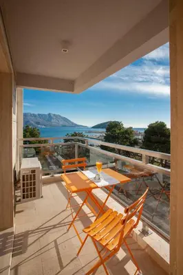 a balcony with a table and chairs and a view of the water at Fontana Hotel & Gastronomy in Budva
