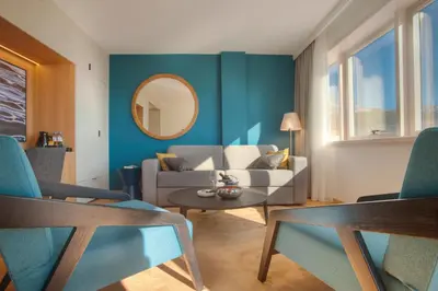 a living room with a couch and a mirror at Fontana Hotel & Gastronomy in Budva