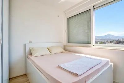 a bed in a room with a window at Apartman Marko in Podgorica