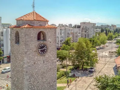 a building with a clock on the side of it at Apartman Marko in Podgorica