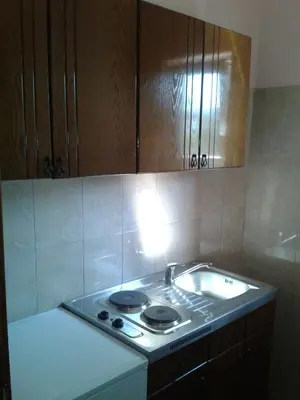a kitchen with a stove top in a kitchen at Apartments Cindrak in Bar