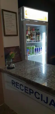 a refrigerator filled with lots of drinks on top of a counter at Apartments Cindrak in Bar