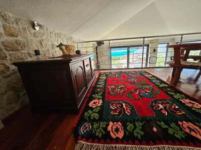 a room with a table and a rug on the floor at Stone Villa UK - Dobra Voda in Bar