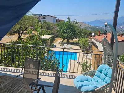 a balcony with chairs and a view of a pool at Stone Villa UK - Dobra Voda in Bar