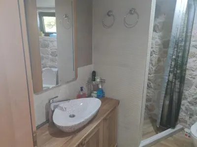 a bathroom with a sink and a mirror at Stone Villa UK - Dobra Voda in Bar