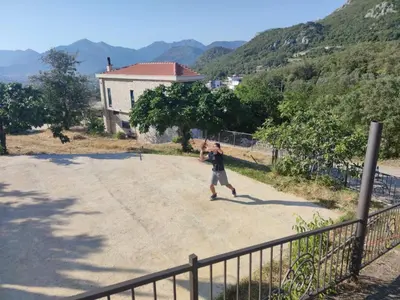 a man is walking down a dirt road at Stone Villa UK - Dobra Voda in Bar