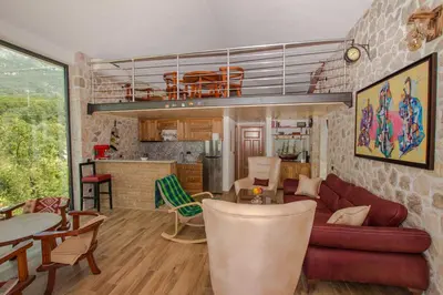 a living room and kitchen with a loft at Stone Villa UK - Dobra Voda in Bar