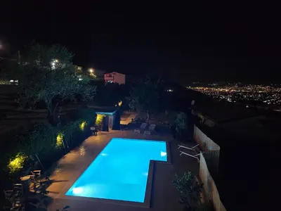 a swimming pool in a backyard at night at Stone Villa UK - Dobra Voda in Bar
