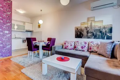 a living room with a couch and a table at Eureka Apartment in Podgorica