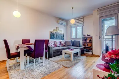 a living room with a couch and a table at Eureka Apartment in Podgorica