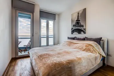 a bedroom with a bed with a picture of the eiffel tower at Eureka Apartment in Podgorica
