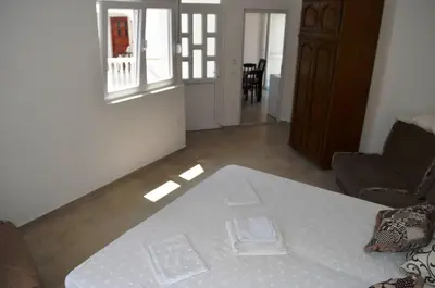 a living room with a couch and a table at Apartmani Miljevci in Sutomore
