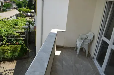 a balcony with two chairs and a table at Apartmani Miljevci in Sutomore