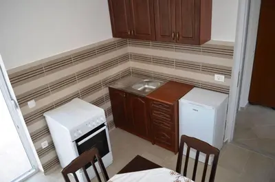 a small kitchen with a sink and a refrigerator at Apartmani Miljevci in Sutomore