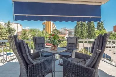 a patio with a table and chairs on a balcony at Marinero Apartments in Budva