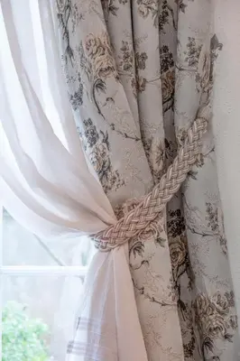 a curtain tied to a window with a rope at Marinero Apartments in Budva