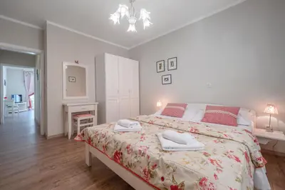 a bedroom with a large bed with two towels on it at Marinero Apartments in Budva