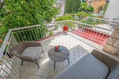 a balcony with two chairs and a table and a couch at Marinero Apartments in Budva