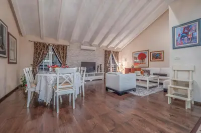 a large living room with a table and chairs at Marinero Apartments in Budva