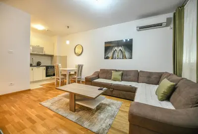 a living room with a couch and a table at Apartment Bono Lux City Kvart in Podgorica