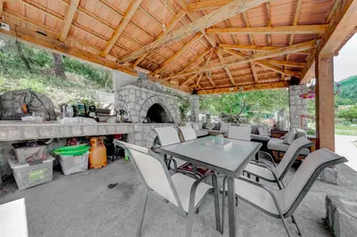 an outdoor patio with a table and chairs at Apartments Pelle in Tivat