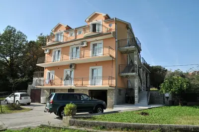a car parked in front of a building at Apartments Pelle in Tivat
