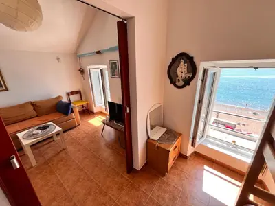 a living room with a couch and a view of the ocean at Apartments LIDO Petrovac in Petrovac na Moru