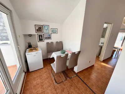 a small dining room with a table and chairs at Apartments LIDO Petrovac in Petrovac na Moru