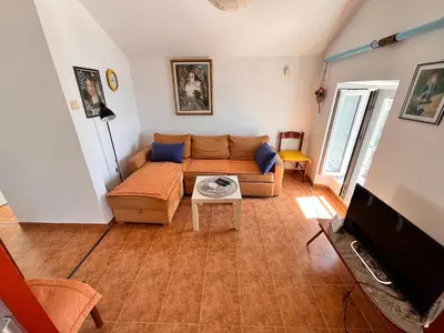 a living room with a couch and a tv at Apartments LIDO Petrovac in Petrovac na Moru