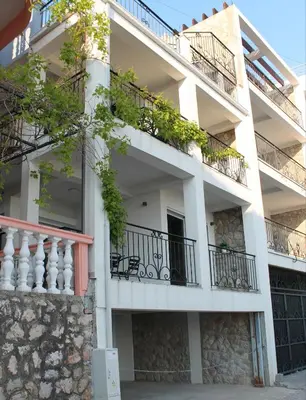 an apartment building with balconies and plants on it at Apartmani Kasija in Dobra Voda