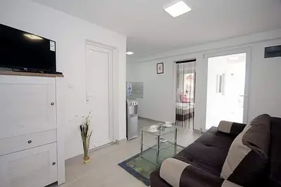 a living room with a couch and a tv at Apartmani Kasija in Dobra Voda