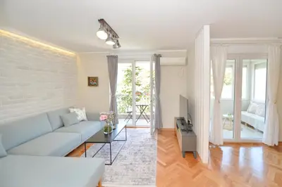 a living room with a couch and a table at The Nest - Urban Family place in Kotor