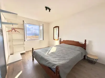 a bedroom with a bed and a window at Sunny balconies apartments Skadar Lake in Virpazar