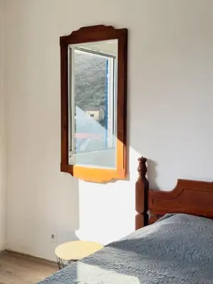 a bedroom with a mirror next to a bed at Sunny balconies apartments Skadar Lake in Virpazar