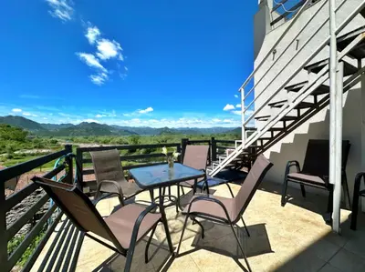 a patio with chairs and a table on a balcony at Sunny balconies apartments Skadar Lake in Virpazar