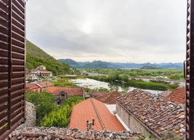 a view of a town with a river and mountains at Sunny balconies apartments Skadar Lake in Virpazar