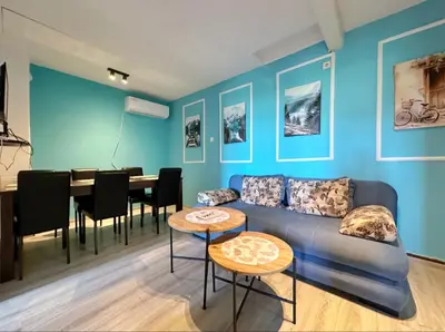 a blue living room with a couch and a table at Sunny balconies apartments Skadar Lake in Virpazar