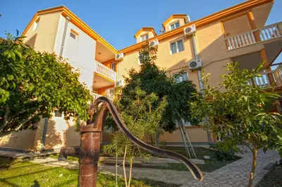 an old water hose in front of a building at Apartments Dalila in Ulcinj
